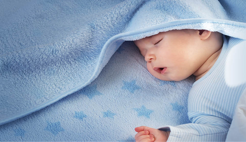 3 month old baby sleeping on blue blanket with stars